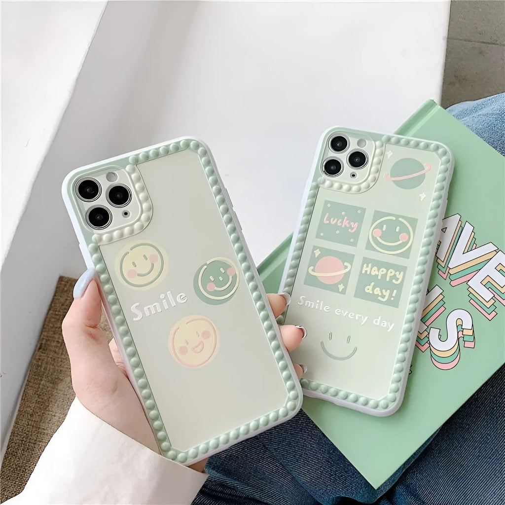 Green TPU iPhone case with polka dot frame and smiley face design on the back.