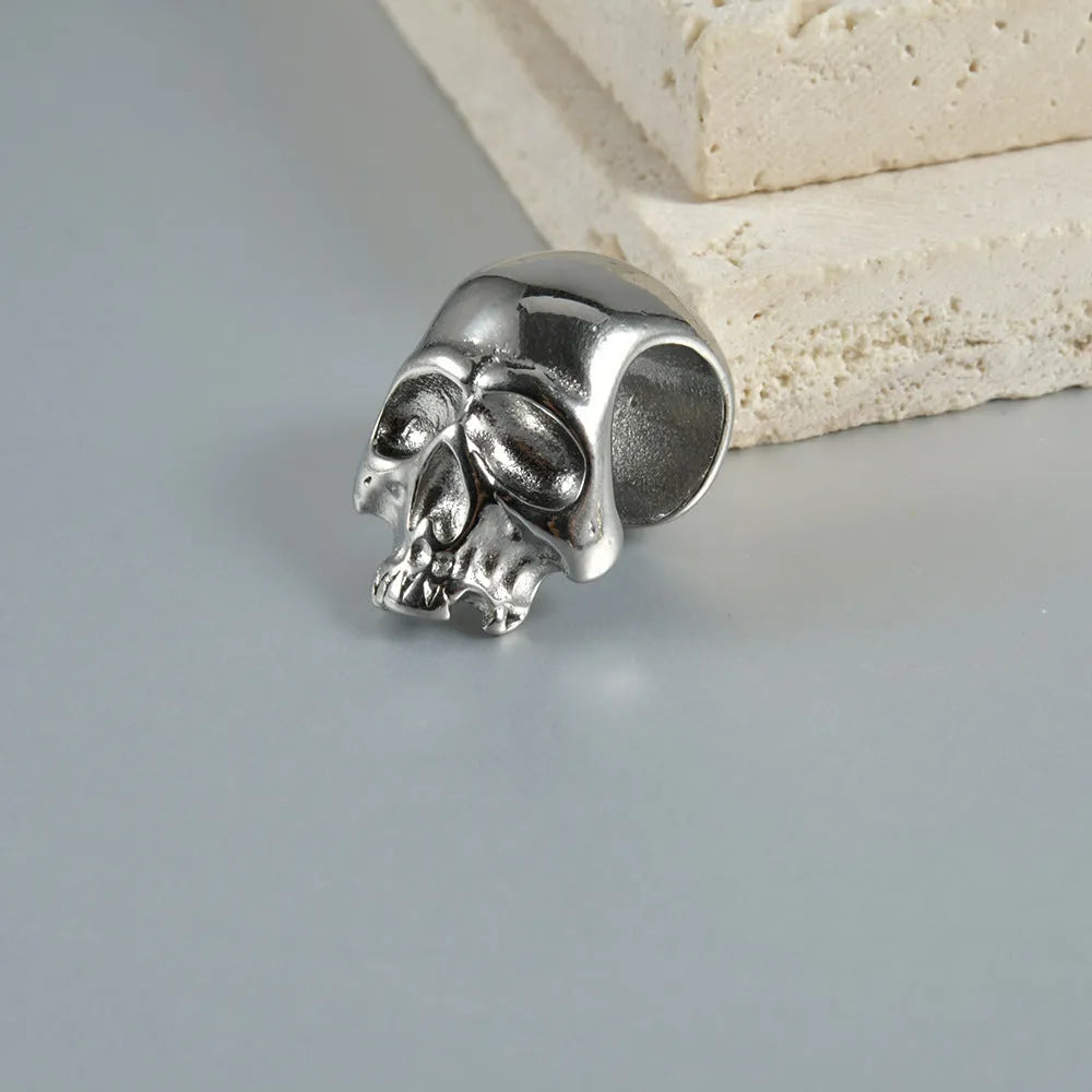 Stainless steel geometric earrings with hollow skull and Buddha head design in electroplated colour options.