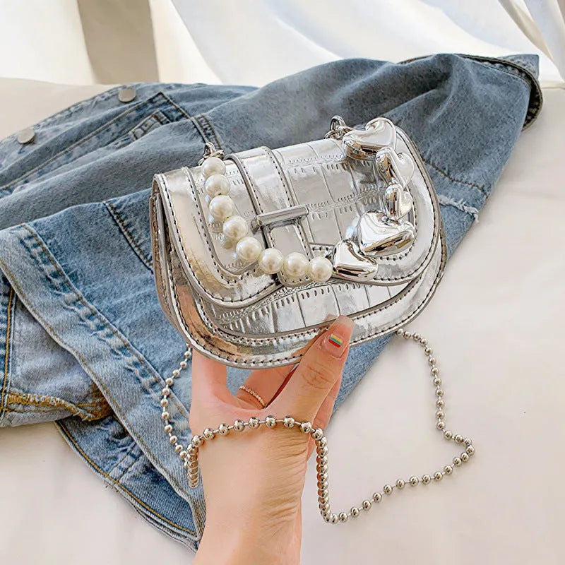 Laser pearl effect mini saddle tote handbag in horizontal square shape with crossbody strap