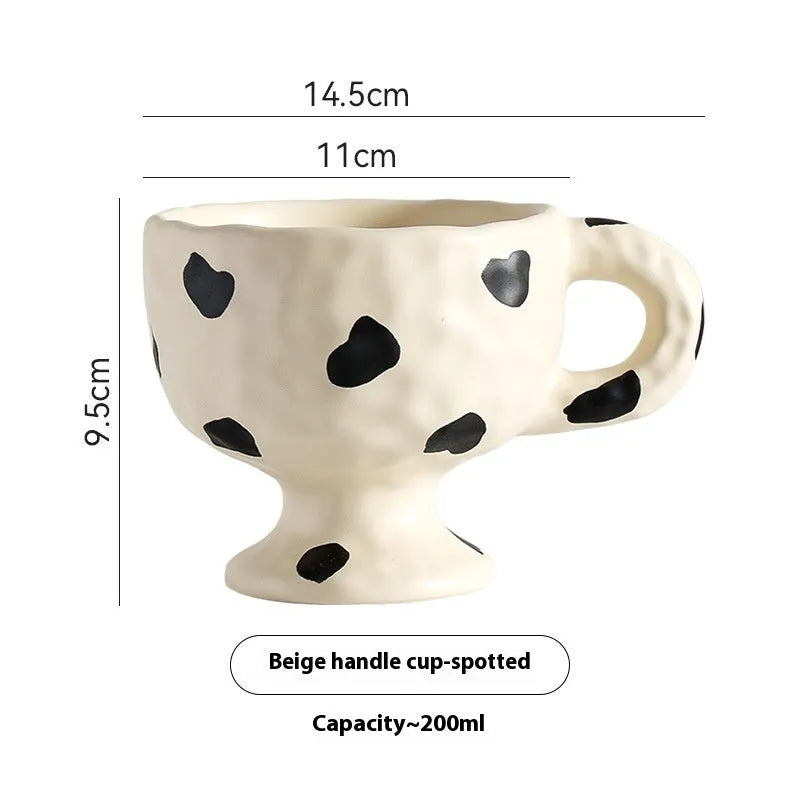 Hand-pinched irregular shaped ceramic mug in a solid colour, shown from the side.