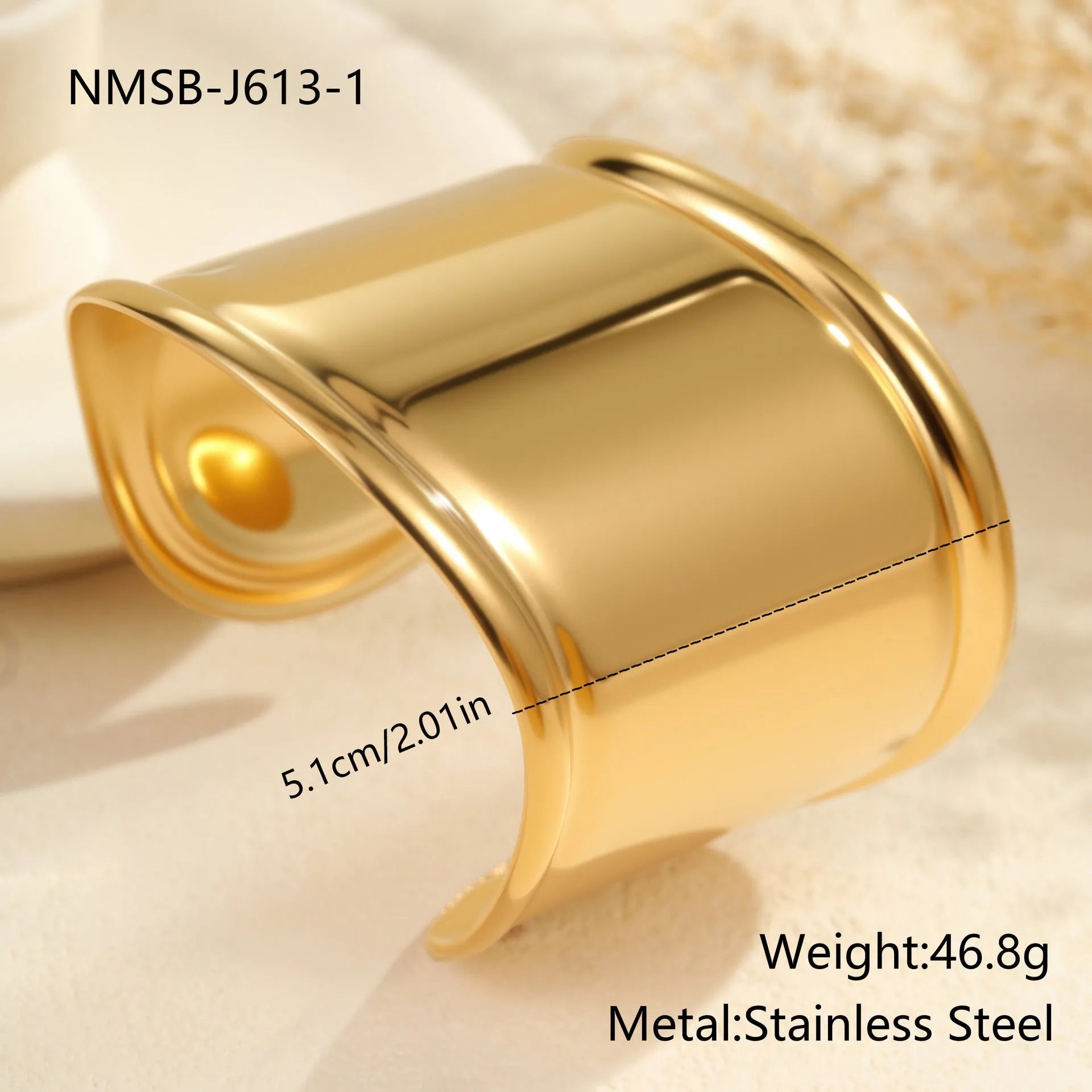 Women's wide stainless steel bracelet with 18K gold plating showing geometric wave patterns