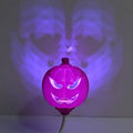 Plastic pumpkin-shaped lamp with USB charging cable, showing purple light option.