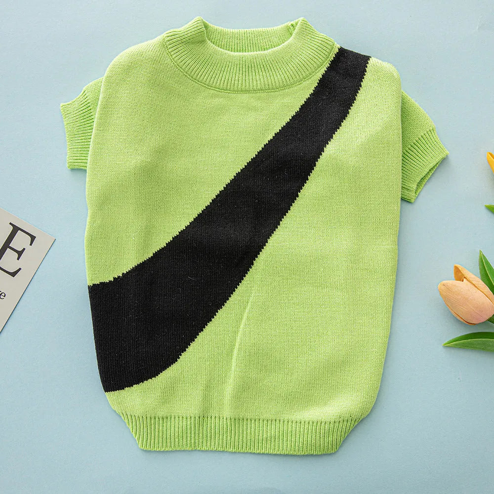 Wool knit dog sweater for corgis and poodles in assorted colours and sizes on a mannequin.