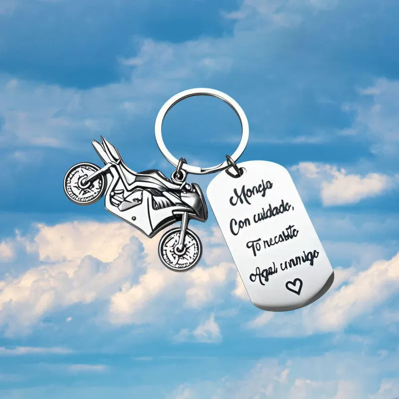 Stainless steel motorcycle keychain with a modern minimalist design, shown with a velvet flannel bag.
