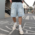 Light blue ripped denim shorts with a loose, straight leg fit and distressed detailing.
