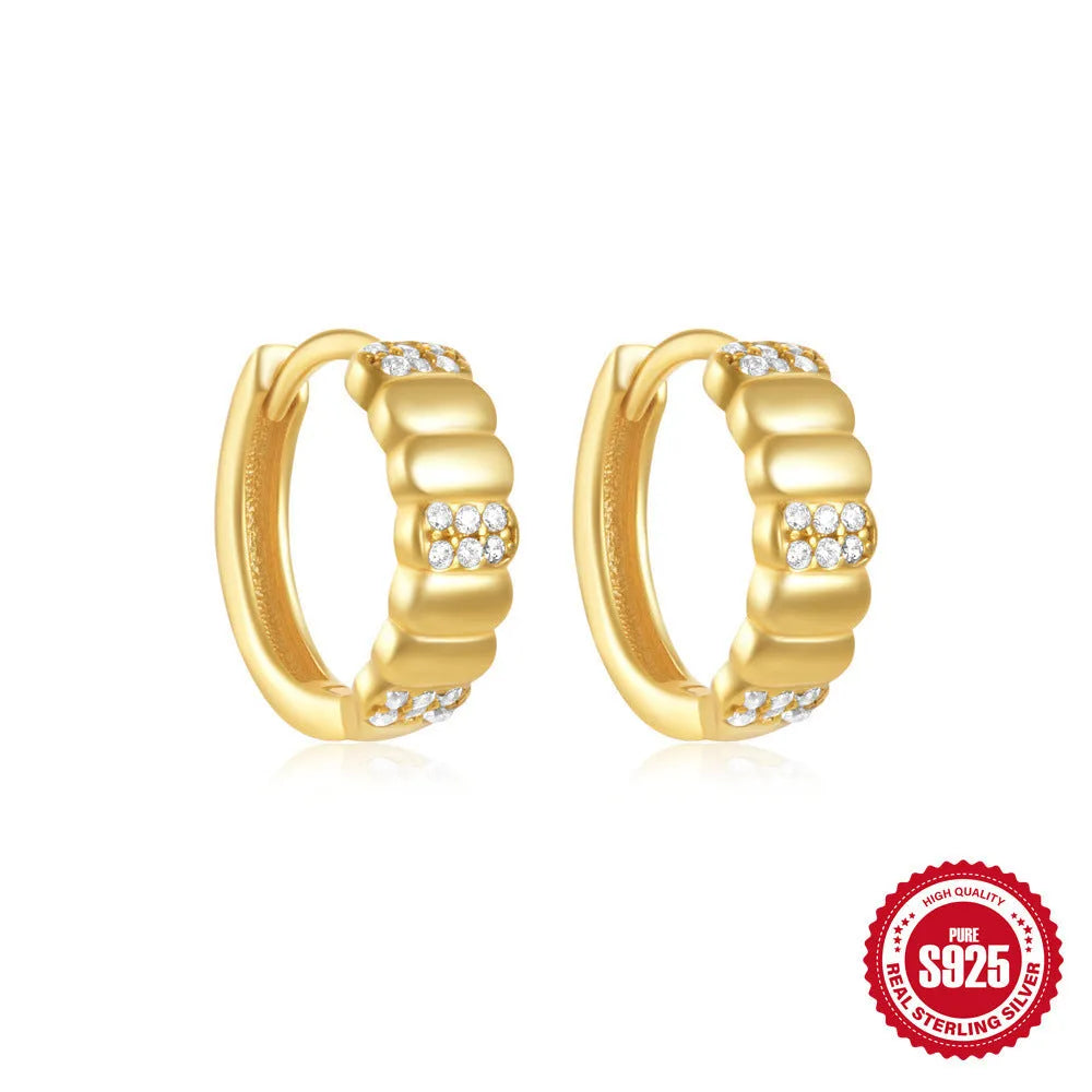 Sterling silver geometric stud earrings with a small round shape and classic diamond detail on a white background.