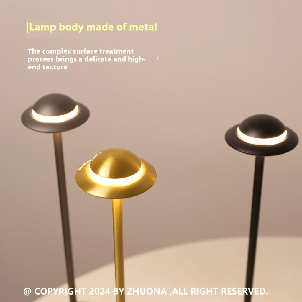 UFO-shaped rechargeable table lamp with touch controls in metallic finish
