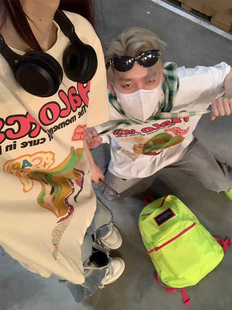 White cartoon hamburger and dog print on a loose-fit cotton T-shirt.
