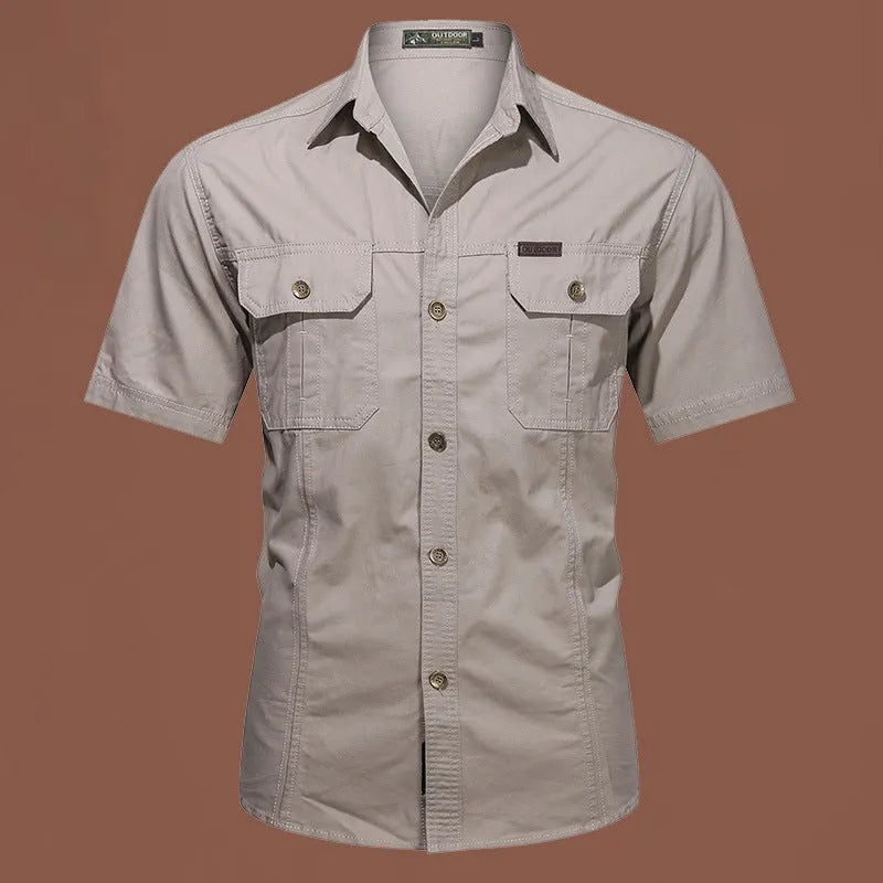 Men's army green cotton work shirt with short sleeves and a loose, non-iron fit.