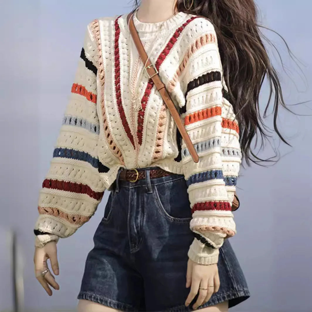 Colourful rainbow striped loose knit sweater with batwing sleeves and a round neck.