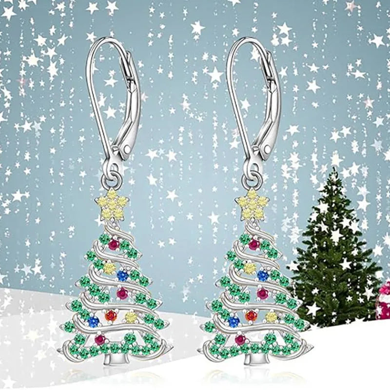 A pair of star-shaped copper earrings with a Christmas tree design, plated in a white gold colour.