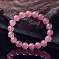 Women's strawberry quartz crystal bracelet with polished beads on an elasticated string.