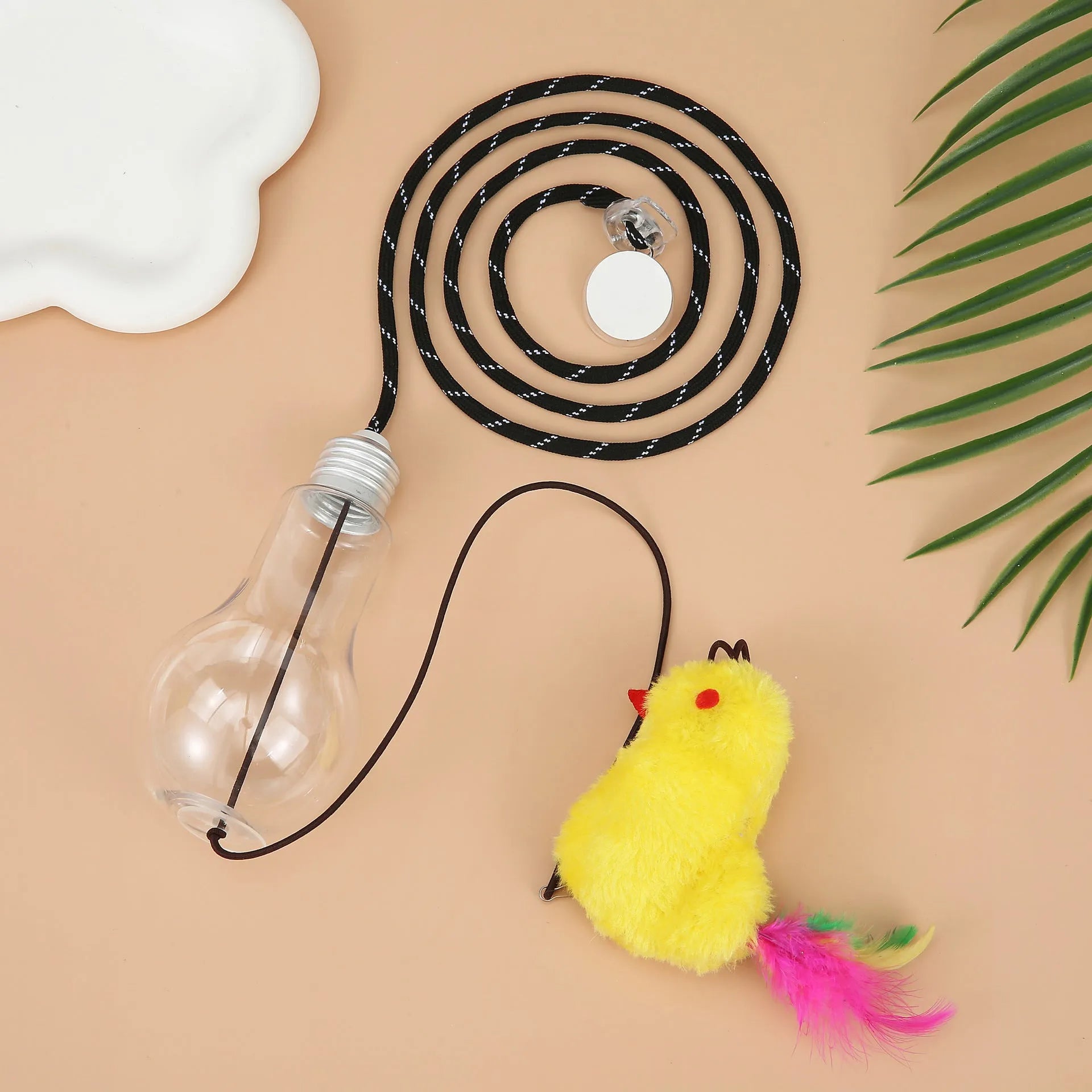 Interactive cat toy hanging from door frame with elastic rope, treat dispenser bulb, and dangling mouse accessory