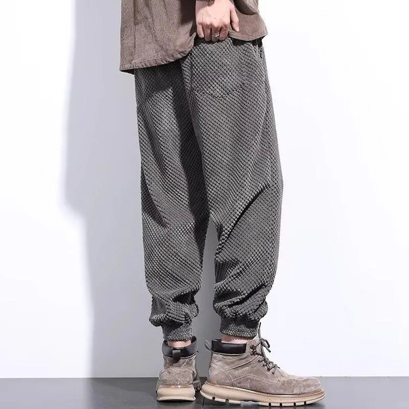 Grey men's straight-leg sweatpants with an ankle tie fastening on the hem.