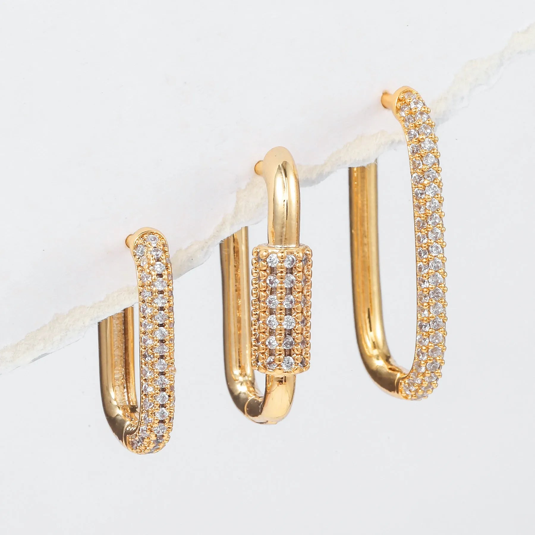 Three geometric square ear clips with micro inlaid zircon detailing in gold and white gold colours