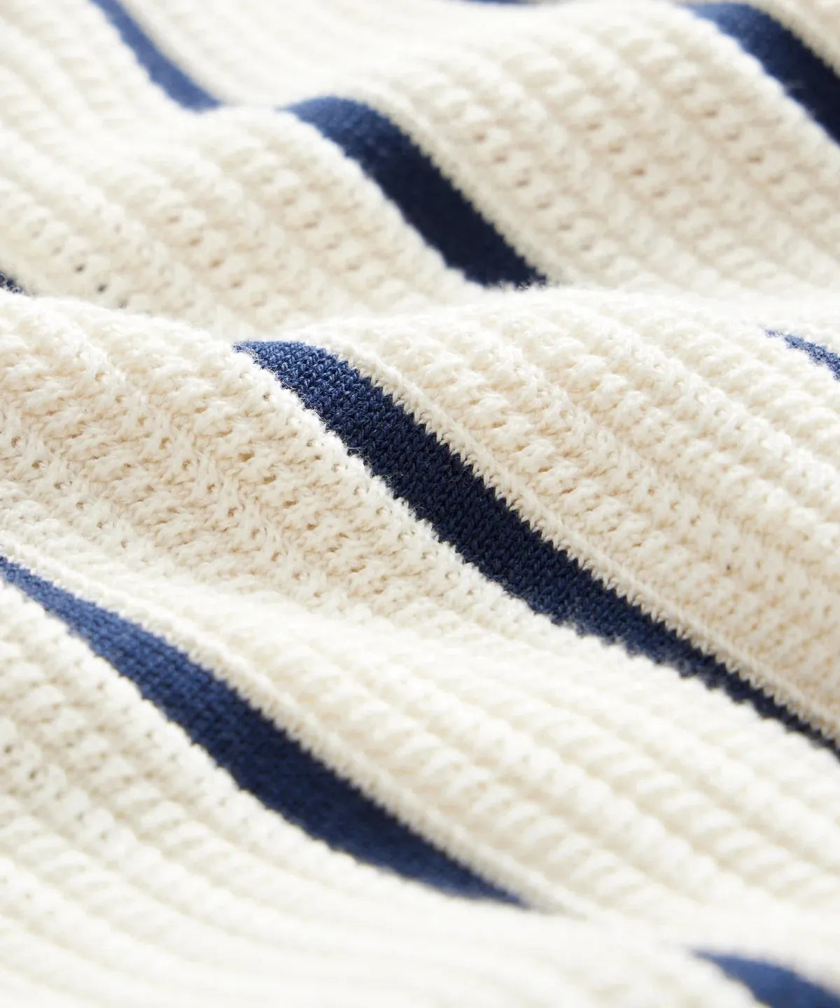 Men's white knitted short sleeve top with asymmetric lapel collar design and striped pattern detail