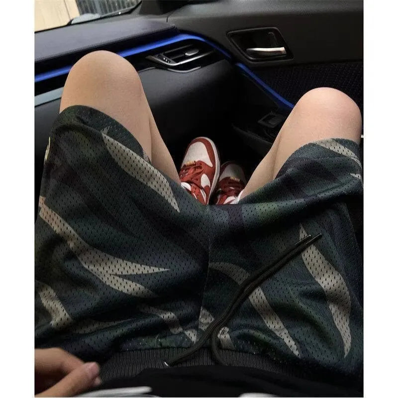 Men's camouflage pattern cotton blend mesh shorts in a straight leg style.