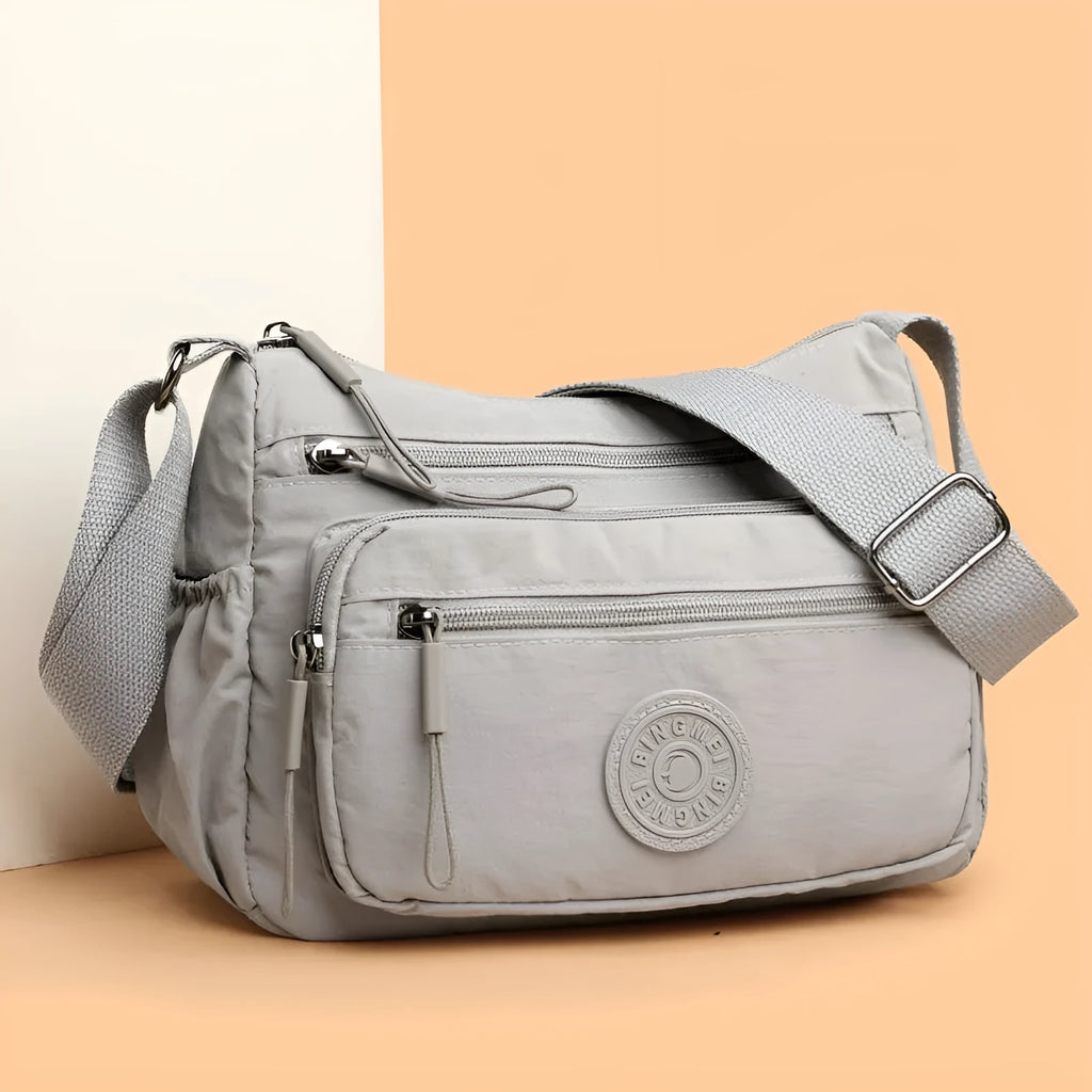 Trendy water-repellent nylon crossbody cloth bag in black with single shoulder strap and outer pocket