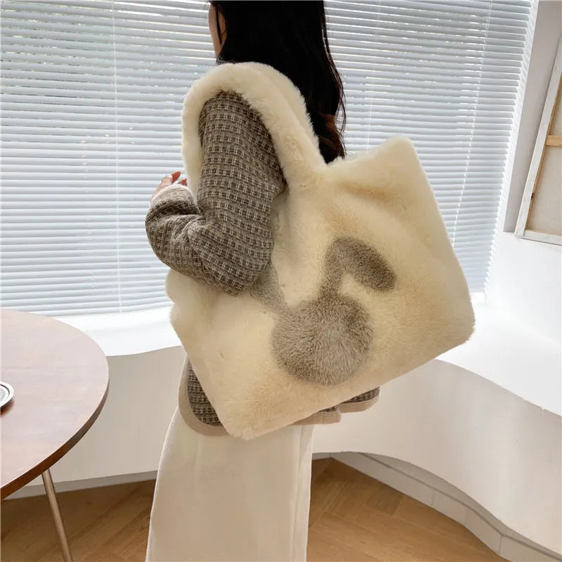 Soft plush shoulder bag with cartoon rabbit ears in one of six solid colours.