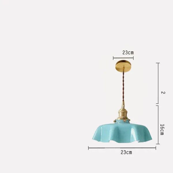 Medieval-style brass flower bud chandelier with a cream glass shade hanging from an adjustable cord.