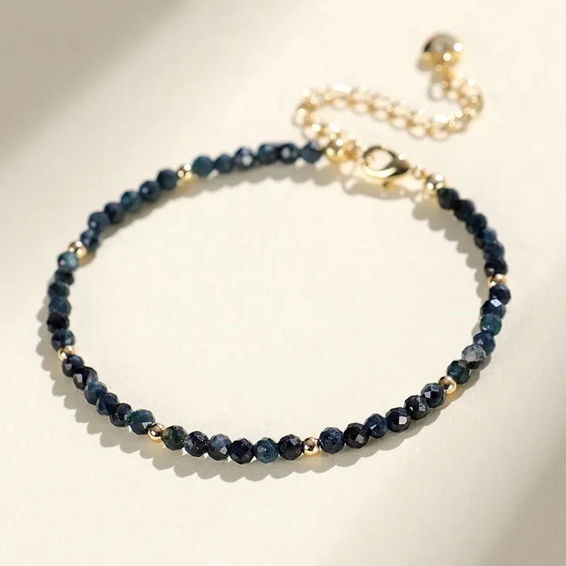 Blue tourmaline bracelet with 3mm beads and spacer bead design on wrist