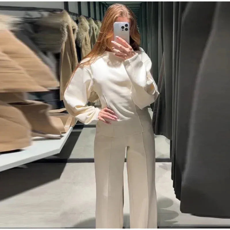 Women's apricot colour polar fleece lounge suit featuring a long sleeve pleated top and wide-leg trousers.