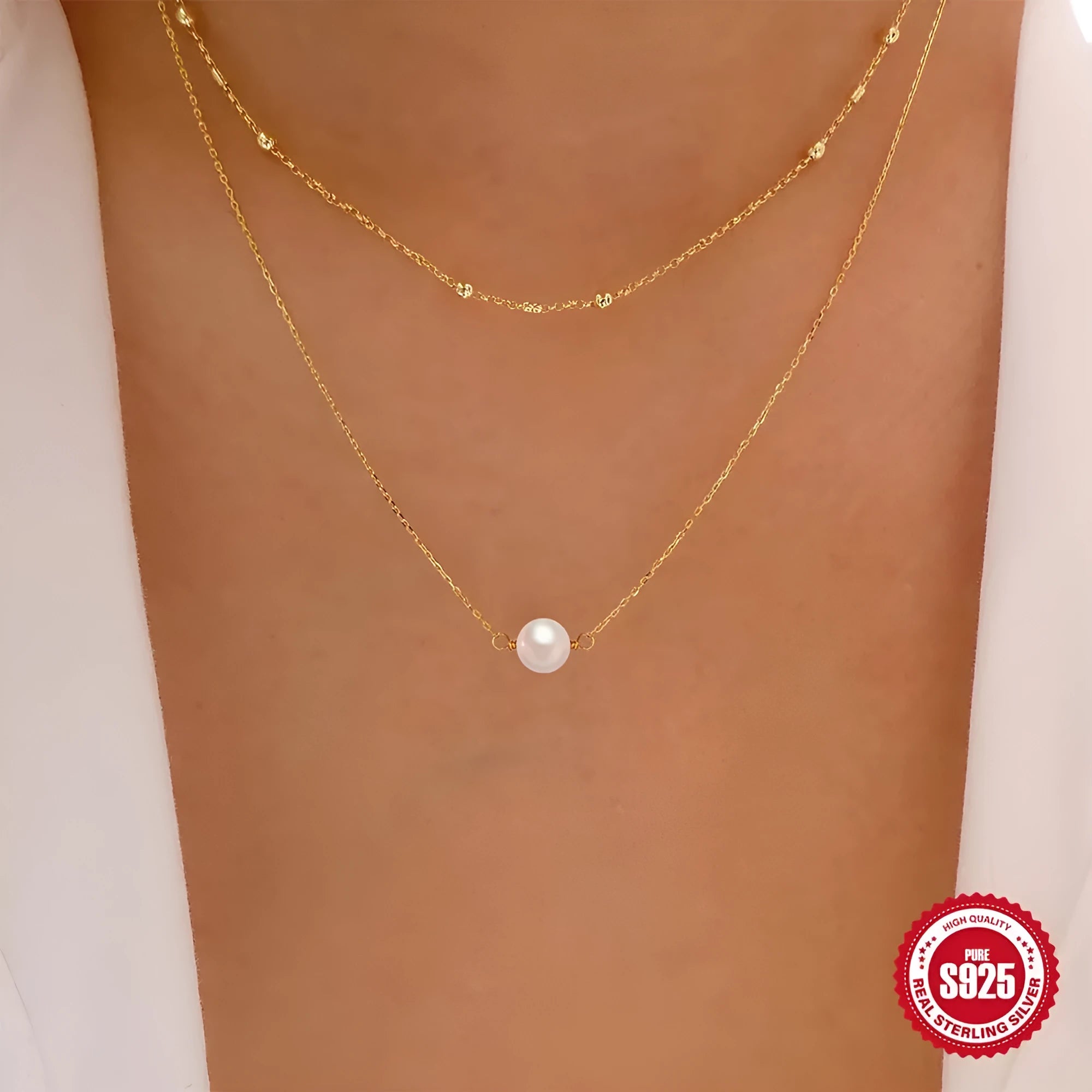 S925 sterling silver double layer necklace with twin pearls in gold or white gold finish featuring geometric pendant and ball bead chain.