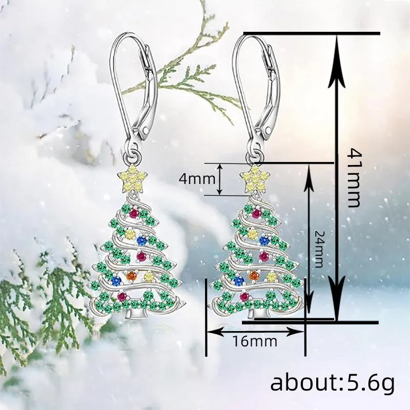 A pair of star-shaped copper earrings with a Christmas tree design, plated in a white gold colour.