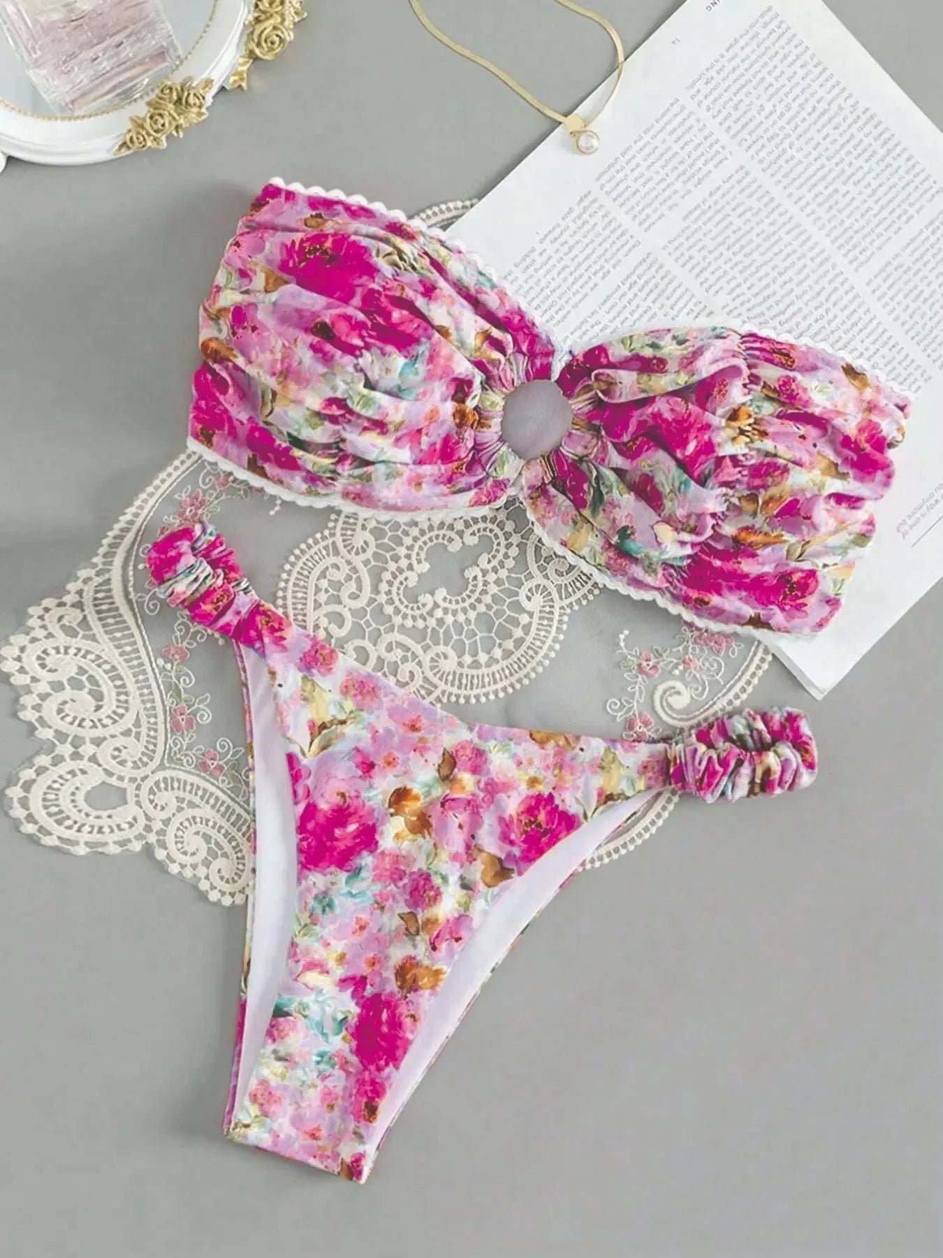 Blue floral print tube top bikini set with lace trim on a mannequin.