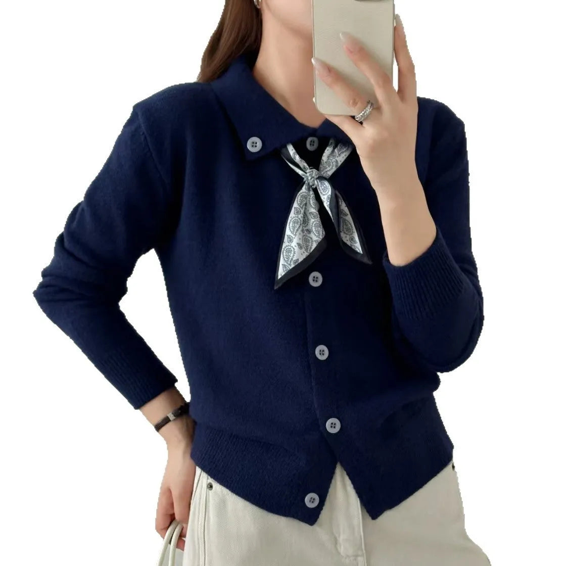 Beige cardigan sweater with a built-in lapel scarf and long sleeves laid flat