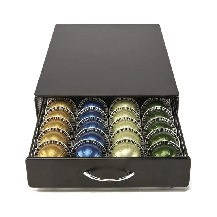 Black coffee capsule storage drawer with silver handle on a cafe countertop