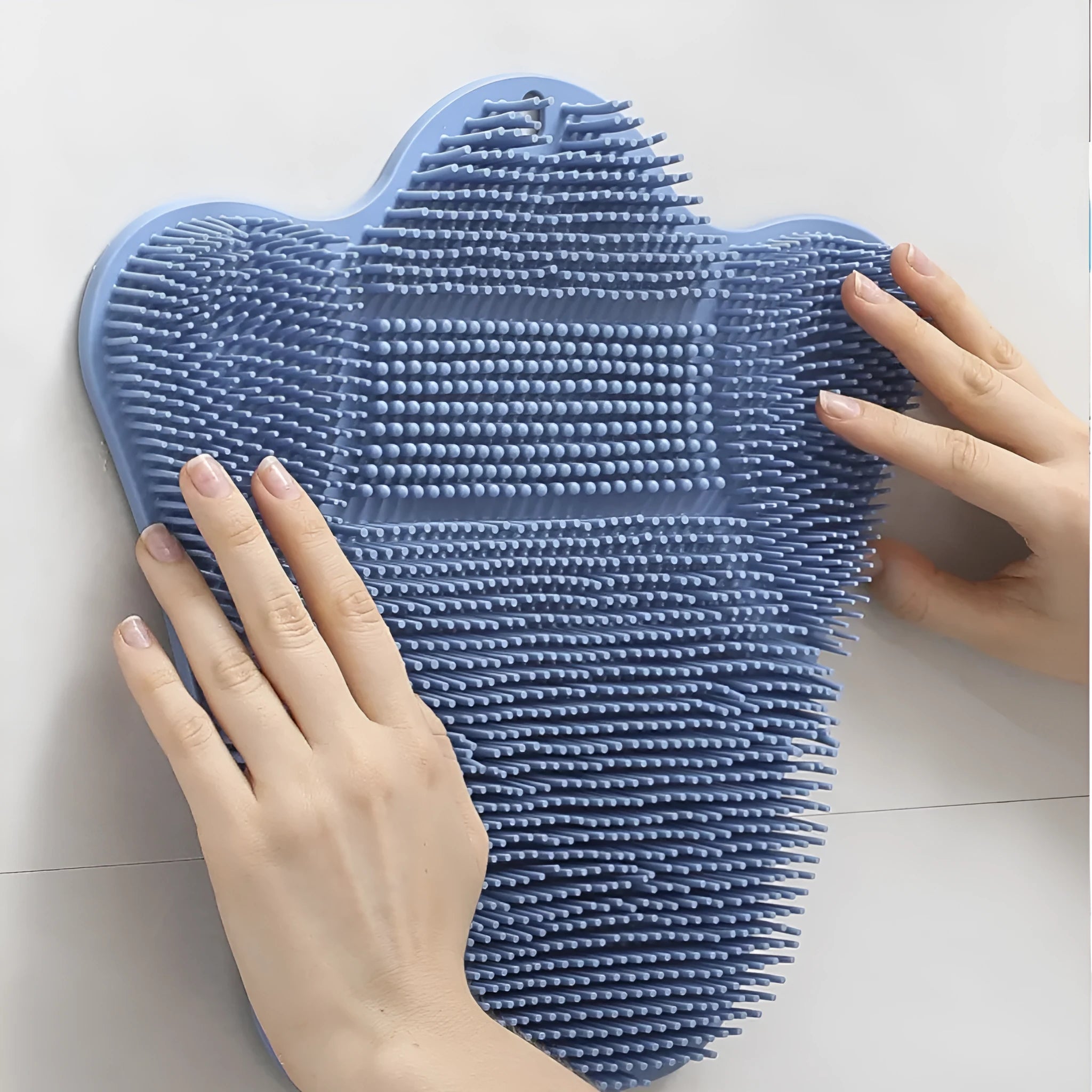 Blue silicone bath brush cushion measuring 31cm by 32cm for body scrubbing