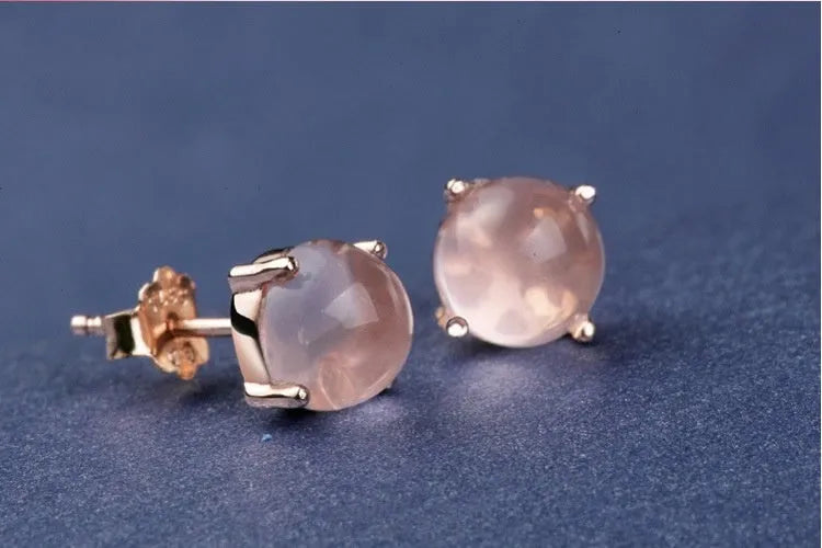 Rose gold coloured drop shape stud earrings with crystal inlay on silver base.
