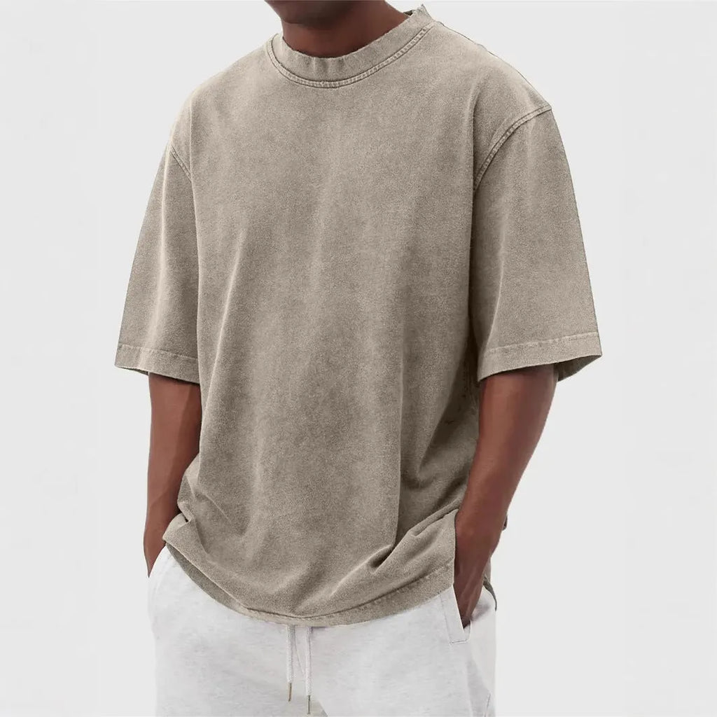 Men's loose-fit stone-washed t-shirt in army green showing distressed texture and pullover style.