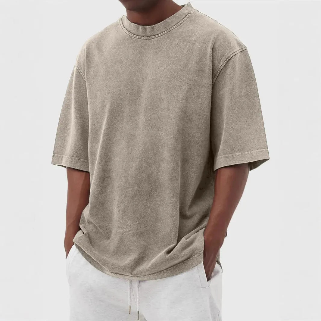Men's loose-fit stone-washed t-shirt in army green showing distressed texture and pullover style.
