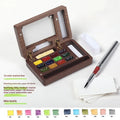 Mini wooden watercolour paint box with pigment suit inside, closed lid showing walnut-colour finish