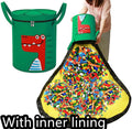 Green felt cube storage bag with a pull rope, laid flat as a play mat.