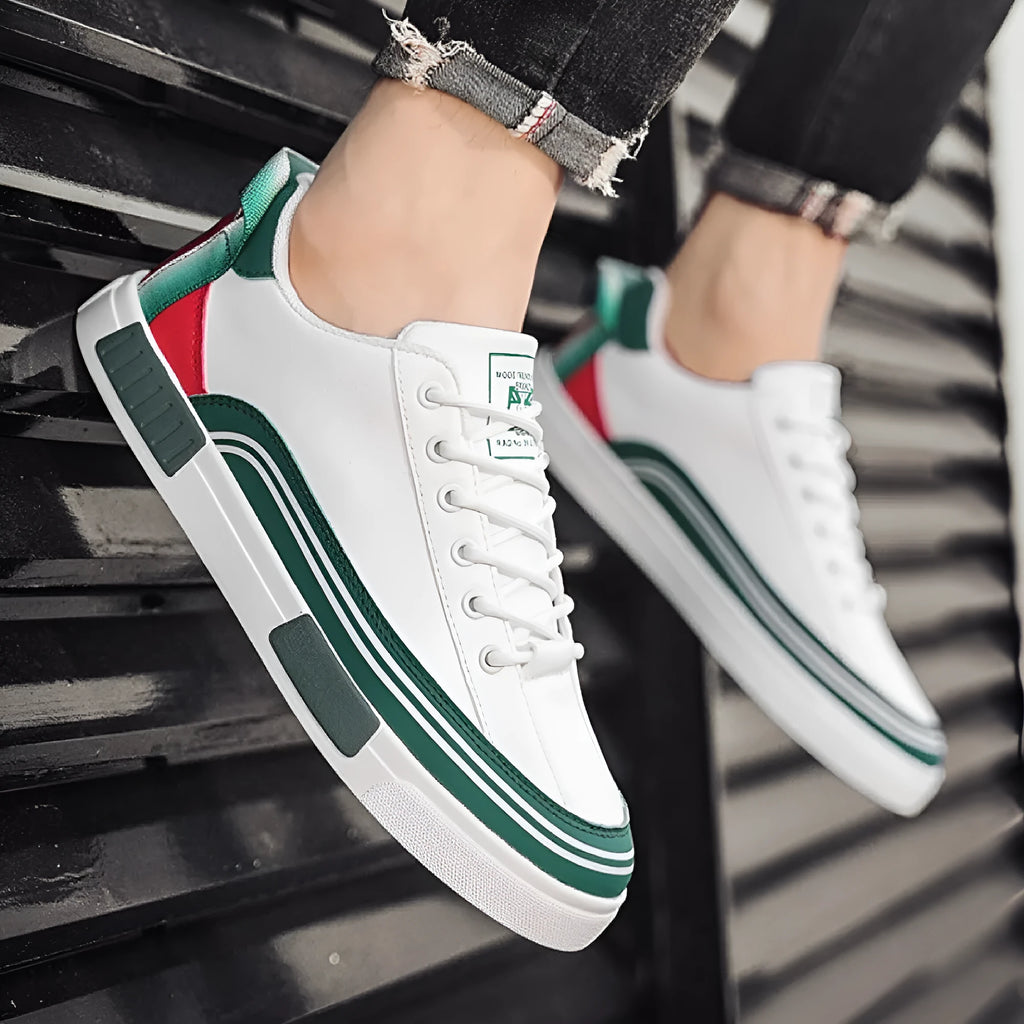 Men's white and green canvas casual shoes with mesh panels and a flat heel.