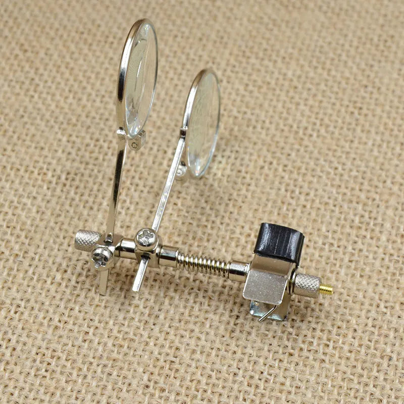 Auxiliary reading glass double clip with metal bracket and glass lenses for clip-on magnification.