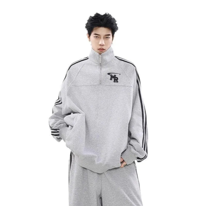 Black retro style men's stand collar hoodie jacket on a grey background.