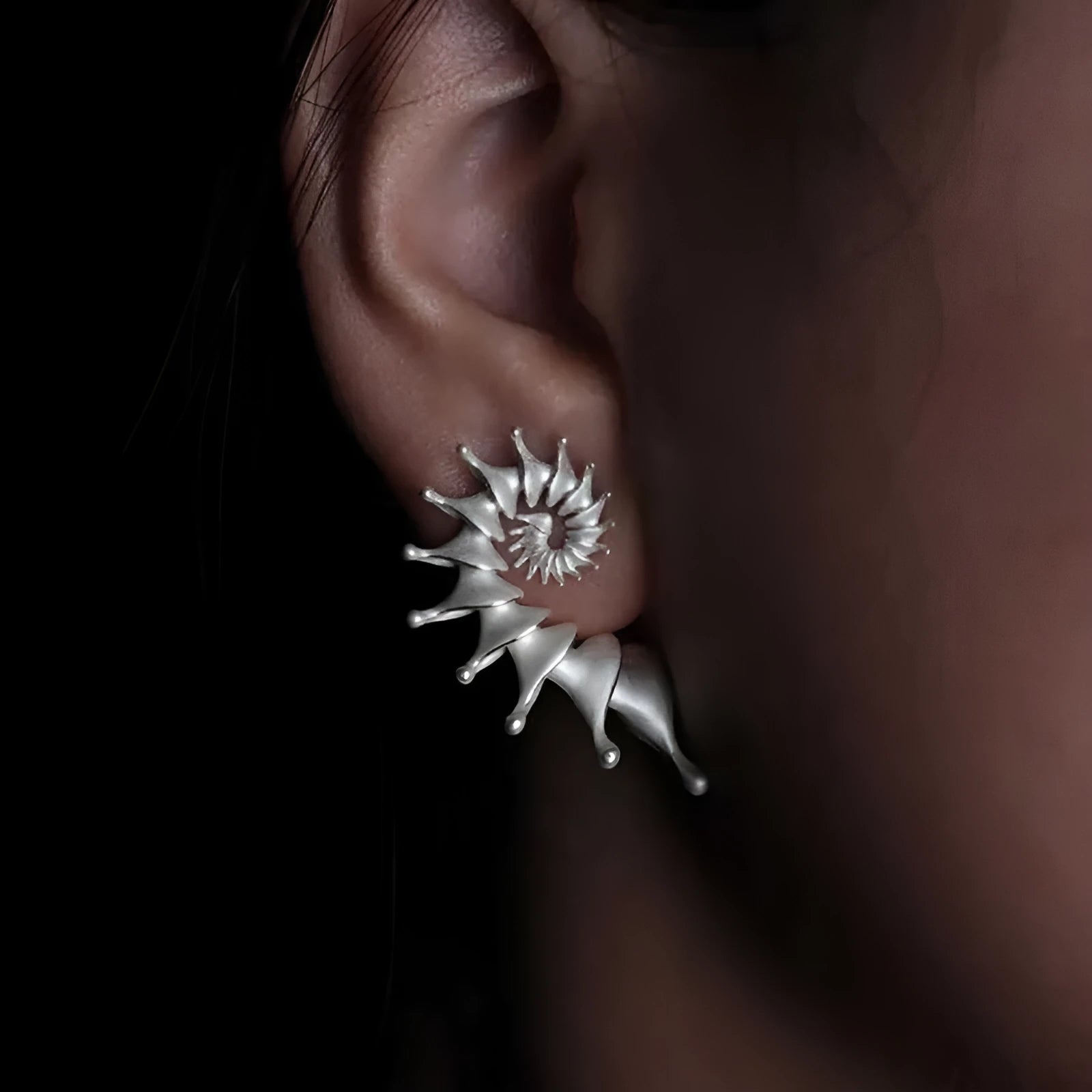 Conch ear studs with exaggerated three-dimensional matte finish and irregular geometric shape
