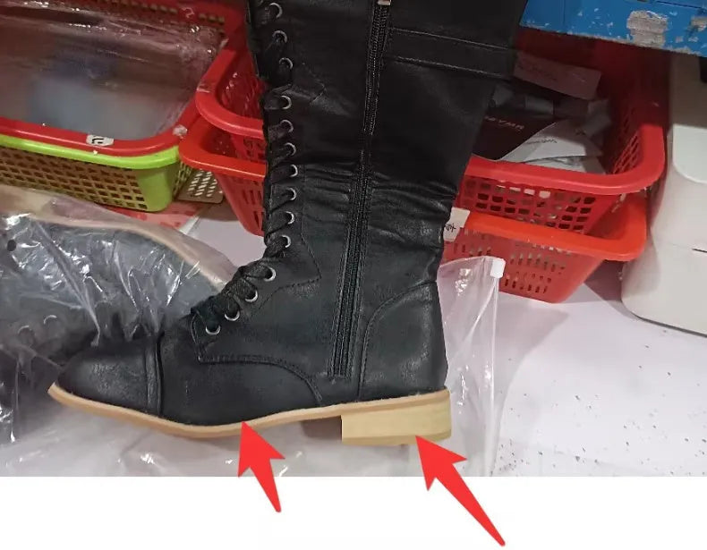 Women's black cross strap knight boots made from artificial PU.