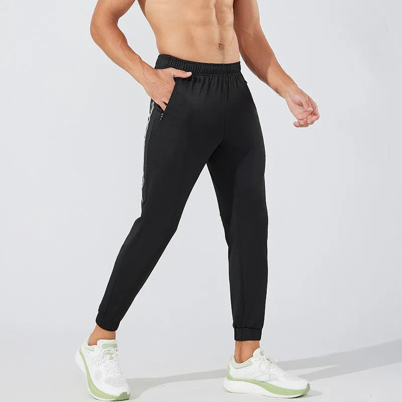 Men's black running trousers with mid waist and full length polyester construction for exercise