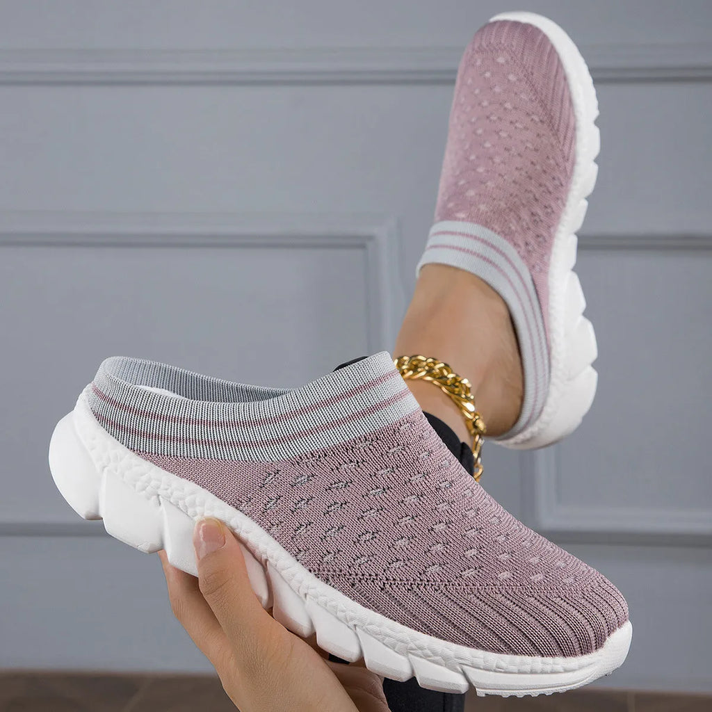 Women's black Flyknit slipper shoes with striped pattern and hollowed-out design on a viscose sole.