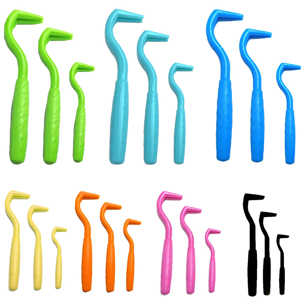 Set of three coloured tick hook removers for dogs on a white background.