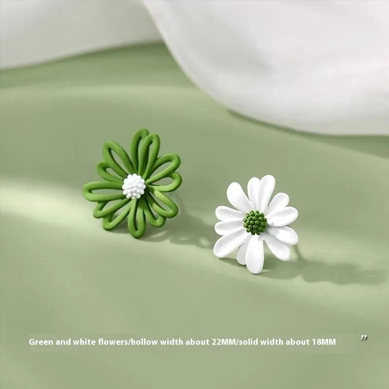 A pair of cartoon-style flower stud earrings in alloy, shown in a two-tone colour option.