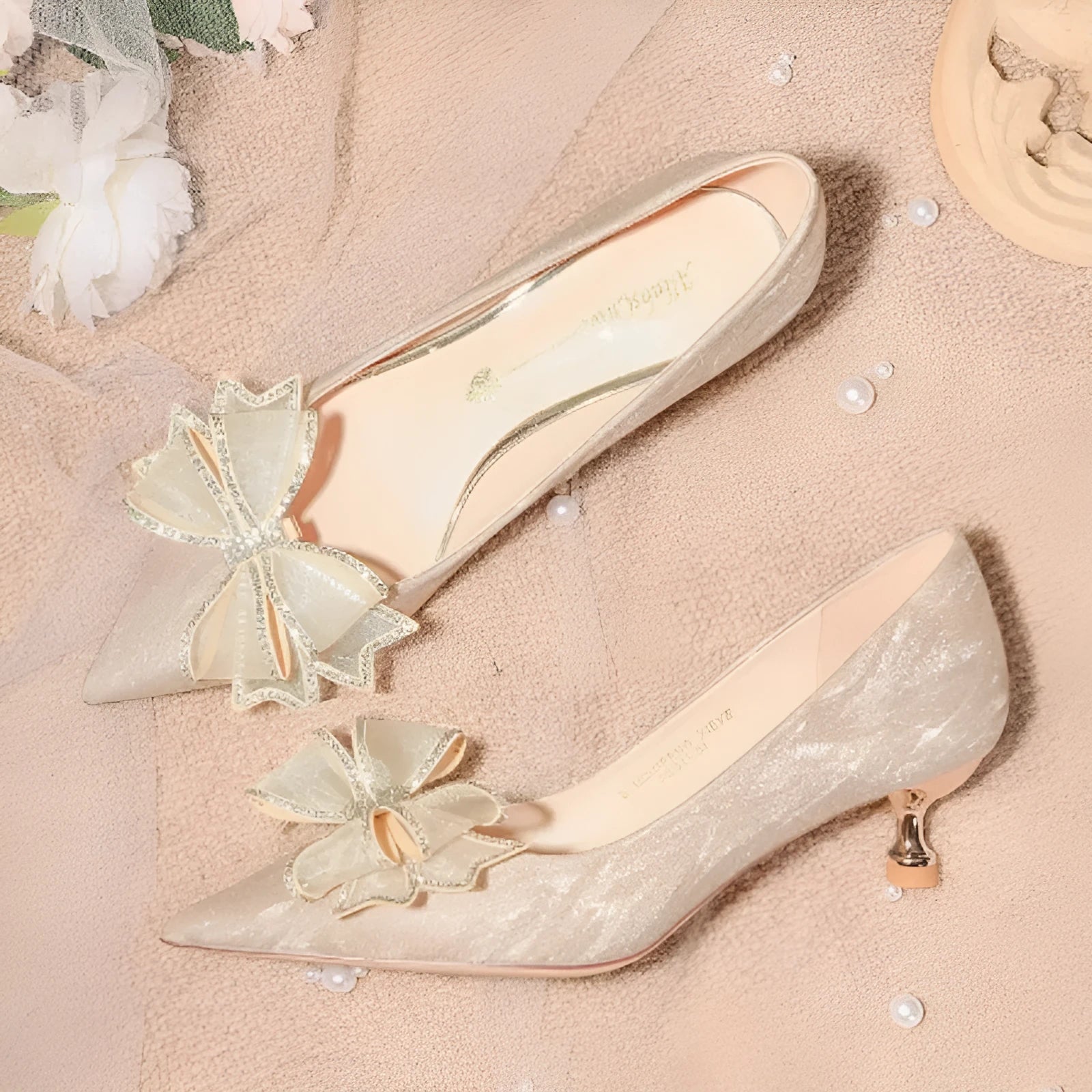 Women's champagne gold stiletto high heels covered in crystal sequins with a pointed toe.