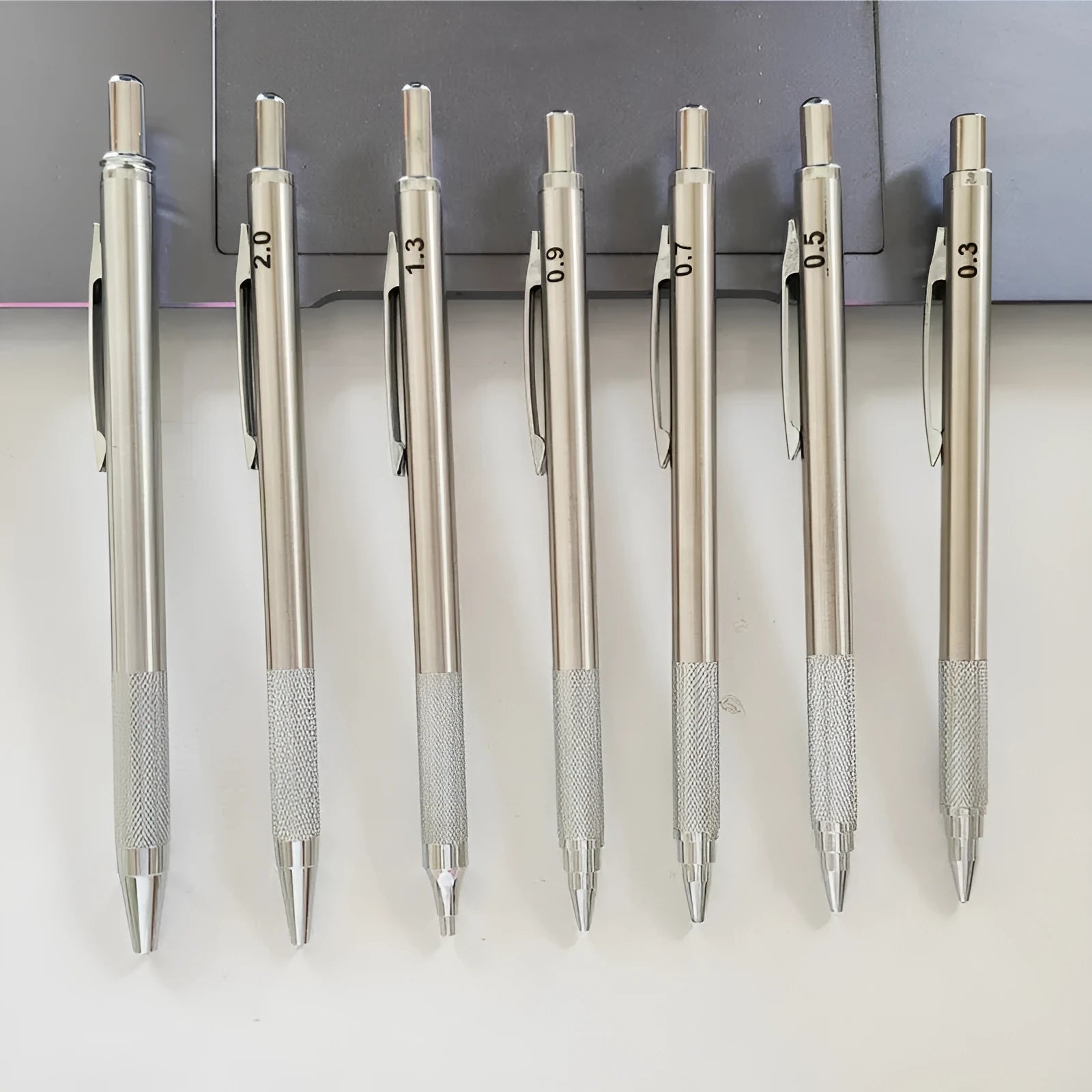 Metal automatic mechanical pencil shown with selection of compatible lead sizes including 0.5mm and 2.0mm.