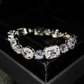 Women's geometric bracelet with zircon stones on silver-toned band showing adjustable and fixed length options