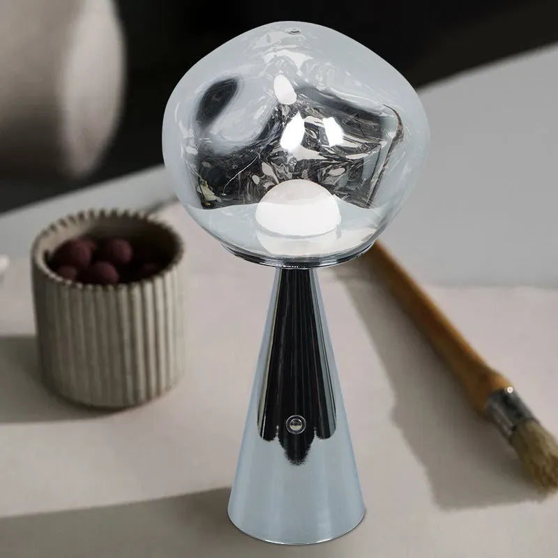 Volcanic lava mini table lamp with metal holder in gold finish, USB magnetic charging, on a bedside table
